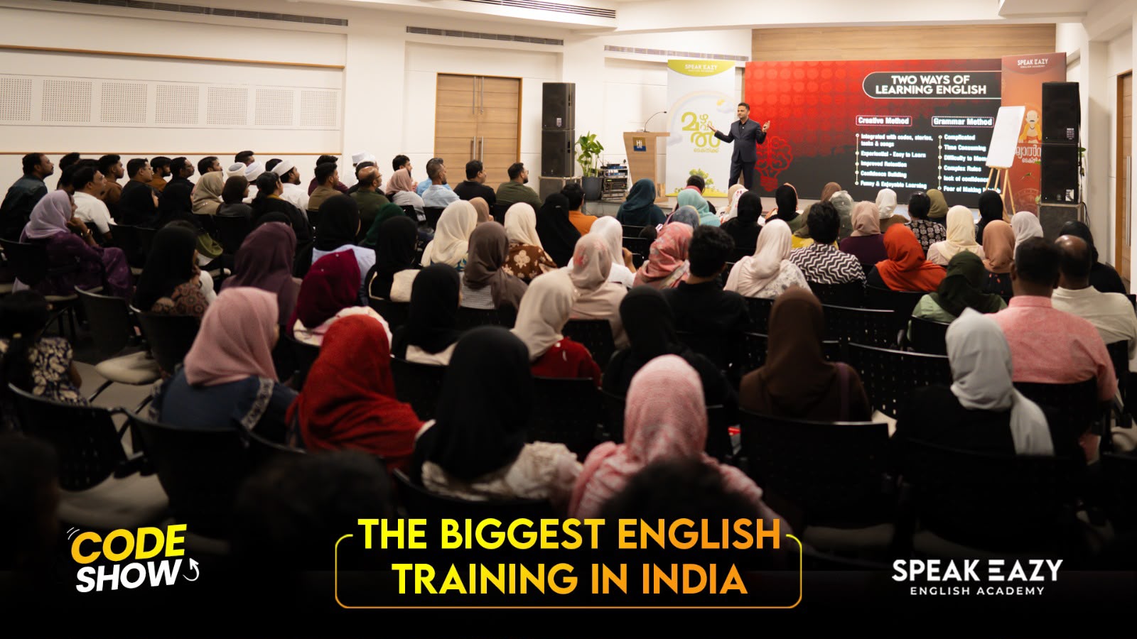 Trainer explaining two ways of learning English to the CODE SHOW audience
